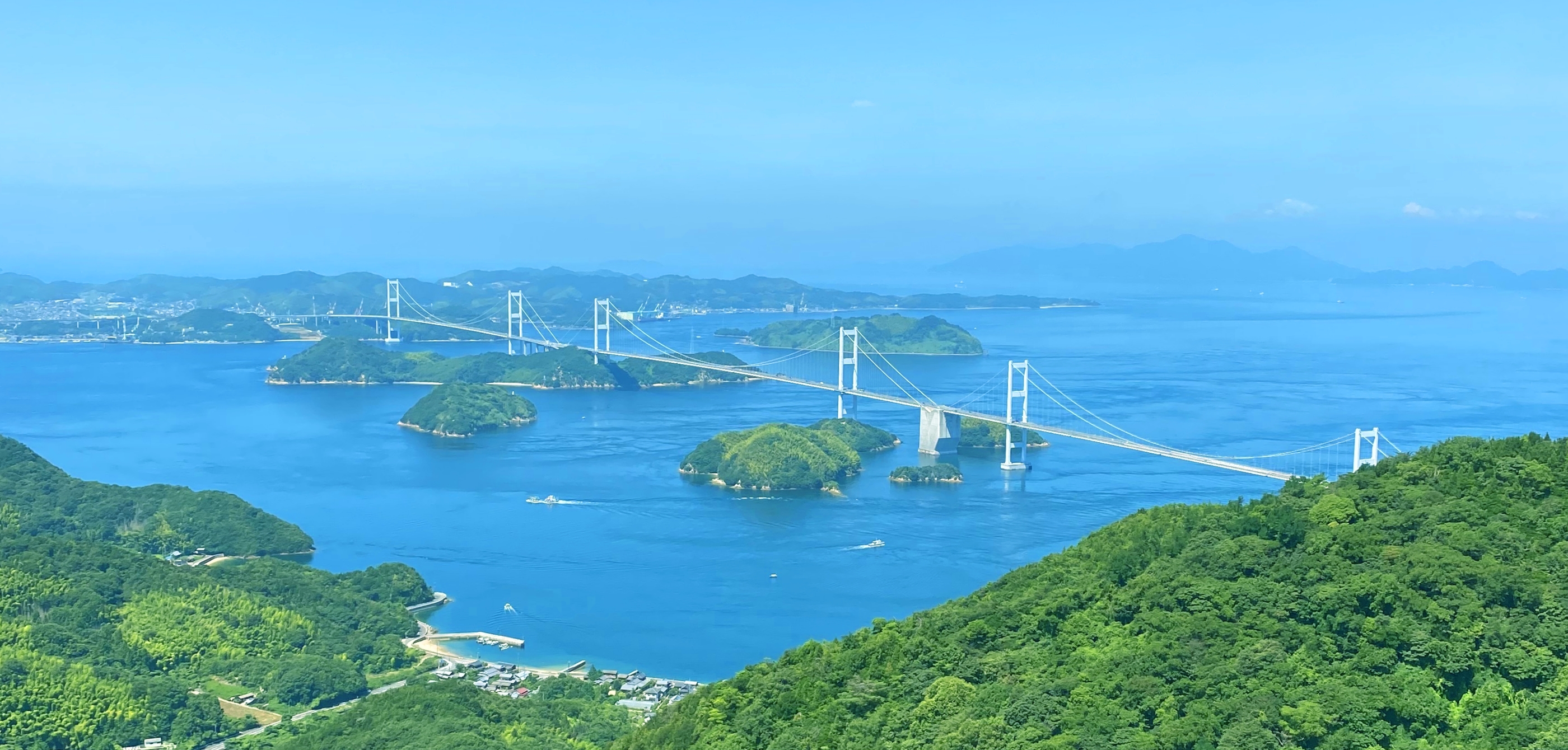 瀬戸内の島々に、来島海峡大橋がかかっている風景